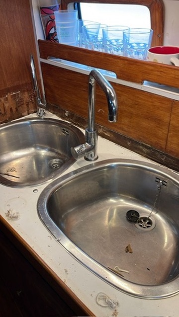 The original galley sinks and taps before the rebuild