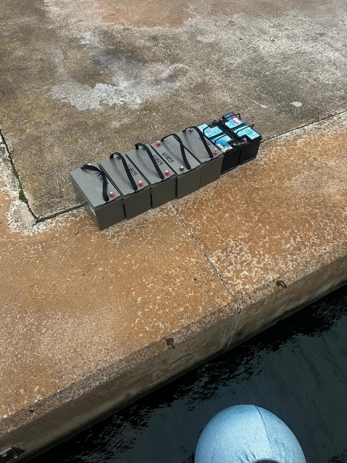 The old lead-acid battery bank on the dockside, on its way to a new home