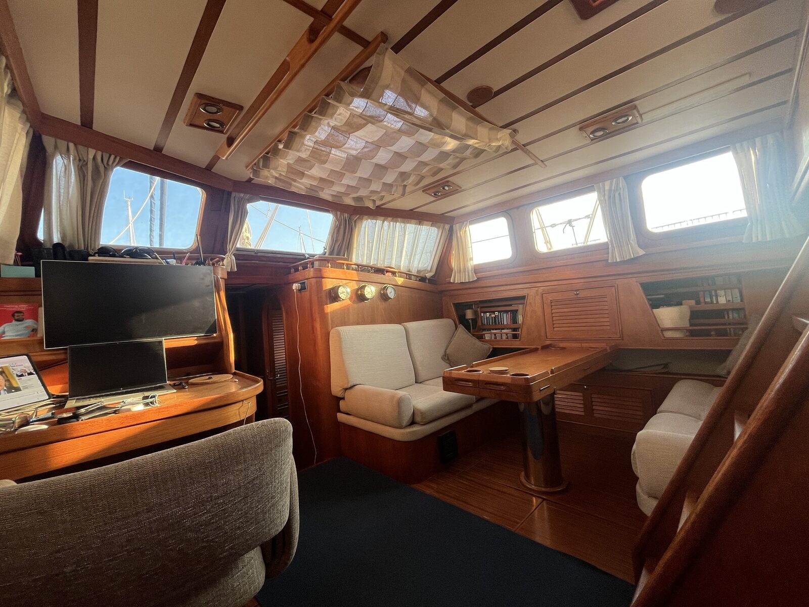 The saloon aboard Gran Blau, with settee, table and chart table